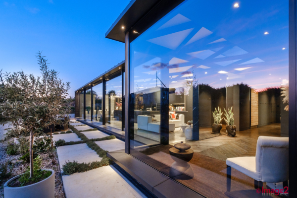 Glass barn extension huge glass frontage photographed at dusk