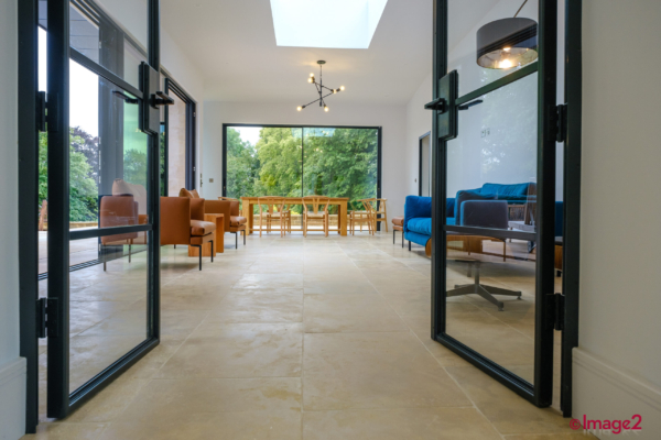 Natural Stone floor in extension leading out to swimming pool area