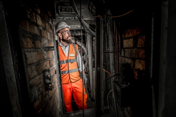 Dramatically lit Construction Engineer working in tunnels London Editorial Photographer