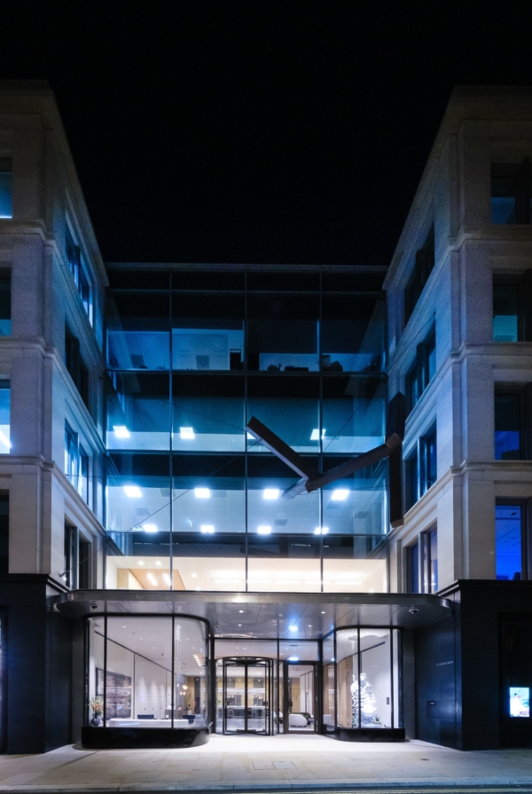 Saville Row Office development showing glass curved windows. Dusk image of office at night.
